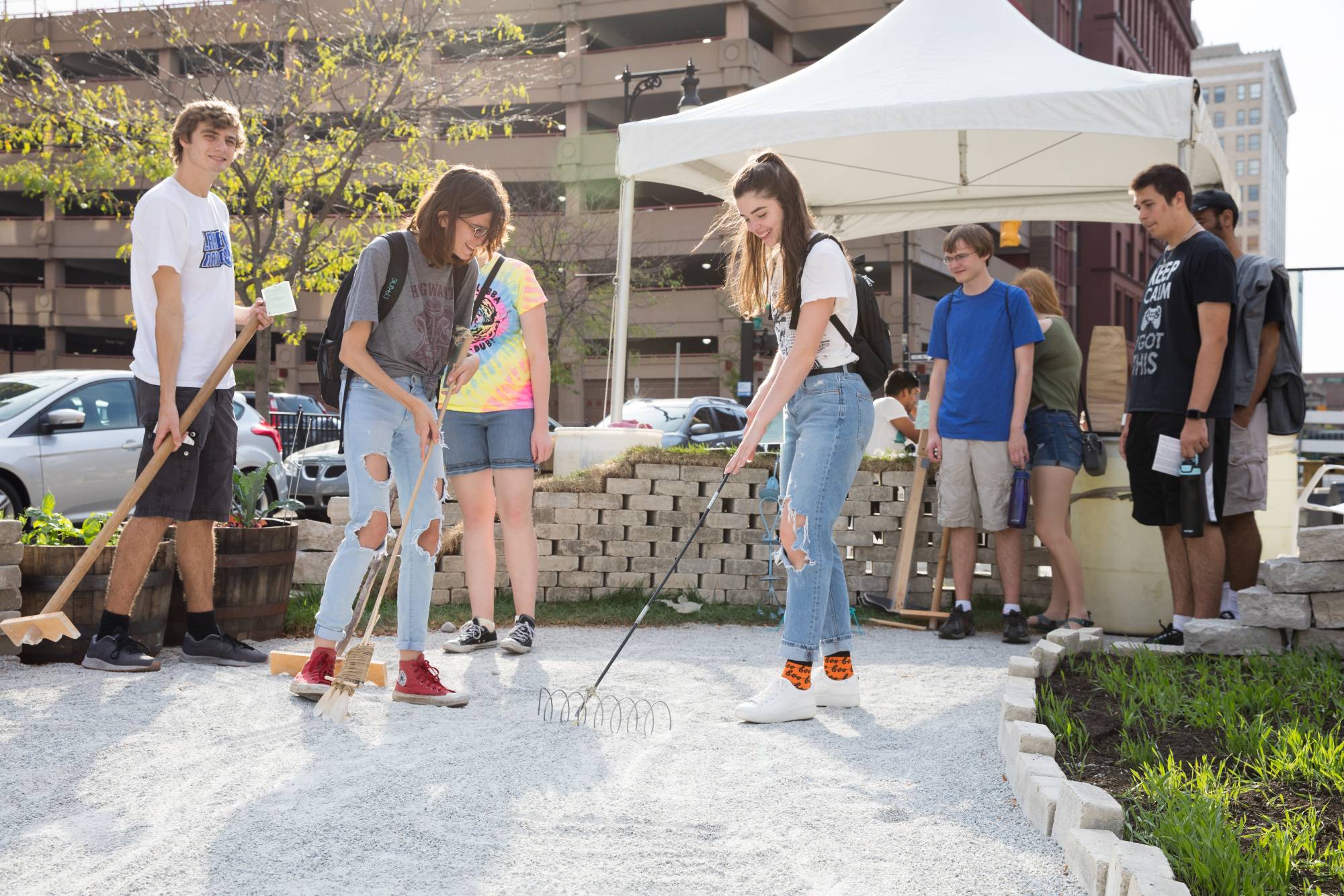 Students raking zen garden